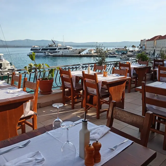 Terrace tables above the Bol harbour in daylight