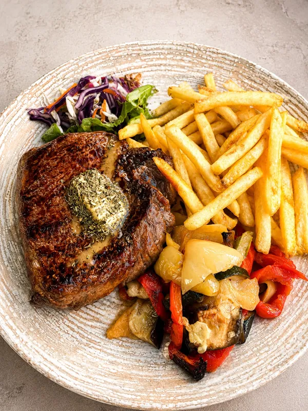 Grilled tenderloin steak with fries and vegetables